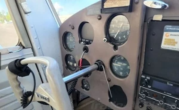A close-up view of the instrument panel and left yoke of a Cessna 150 cockpit.