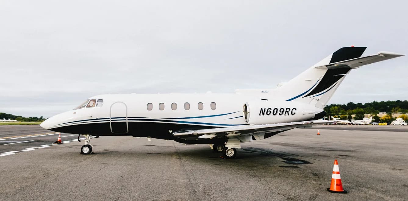 A Hawker 800XP aircraft with registration N609RC is parked on the tarmac.