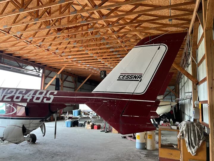 Tail section of a Cessna aircraft inside a hangar.