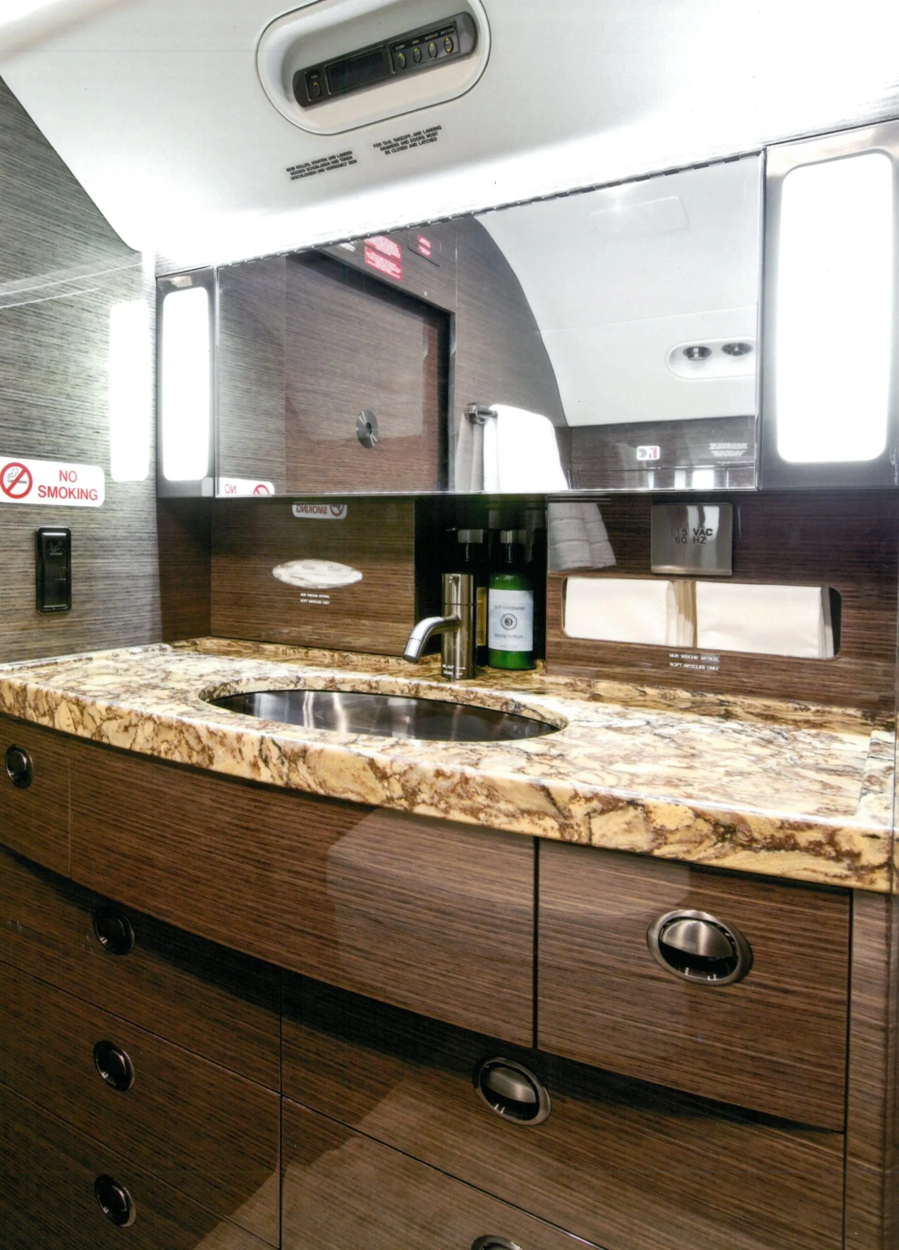 View of the aircraft lavatory with a marble countertop.