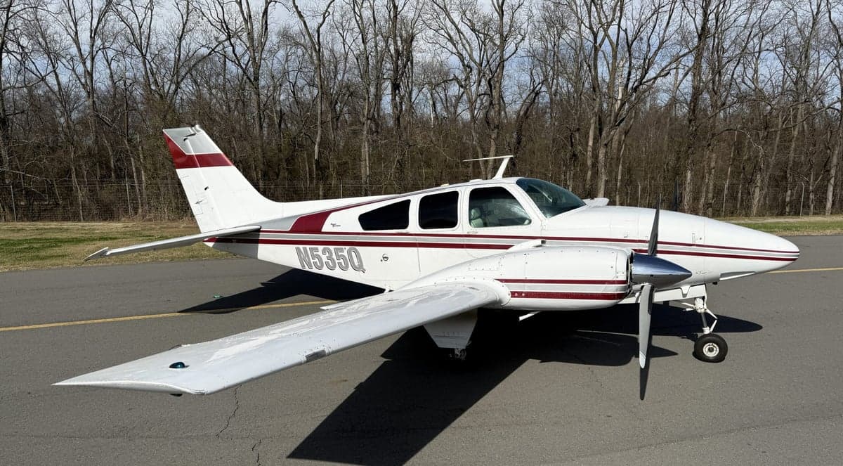 N535Q Beechcraft on the tarmac with a white and maroon paint scheme.