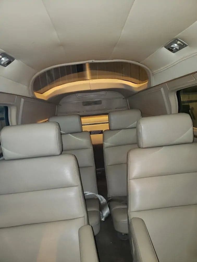 View of the aircraft's cabin with light-colored leather seats.