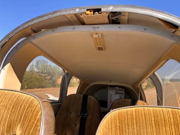 View of the aircraft's cabin interior, including the seats and headliner.