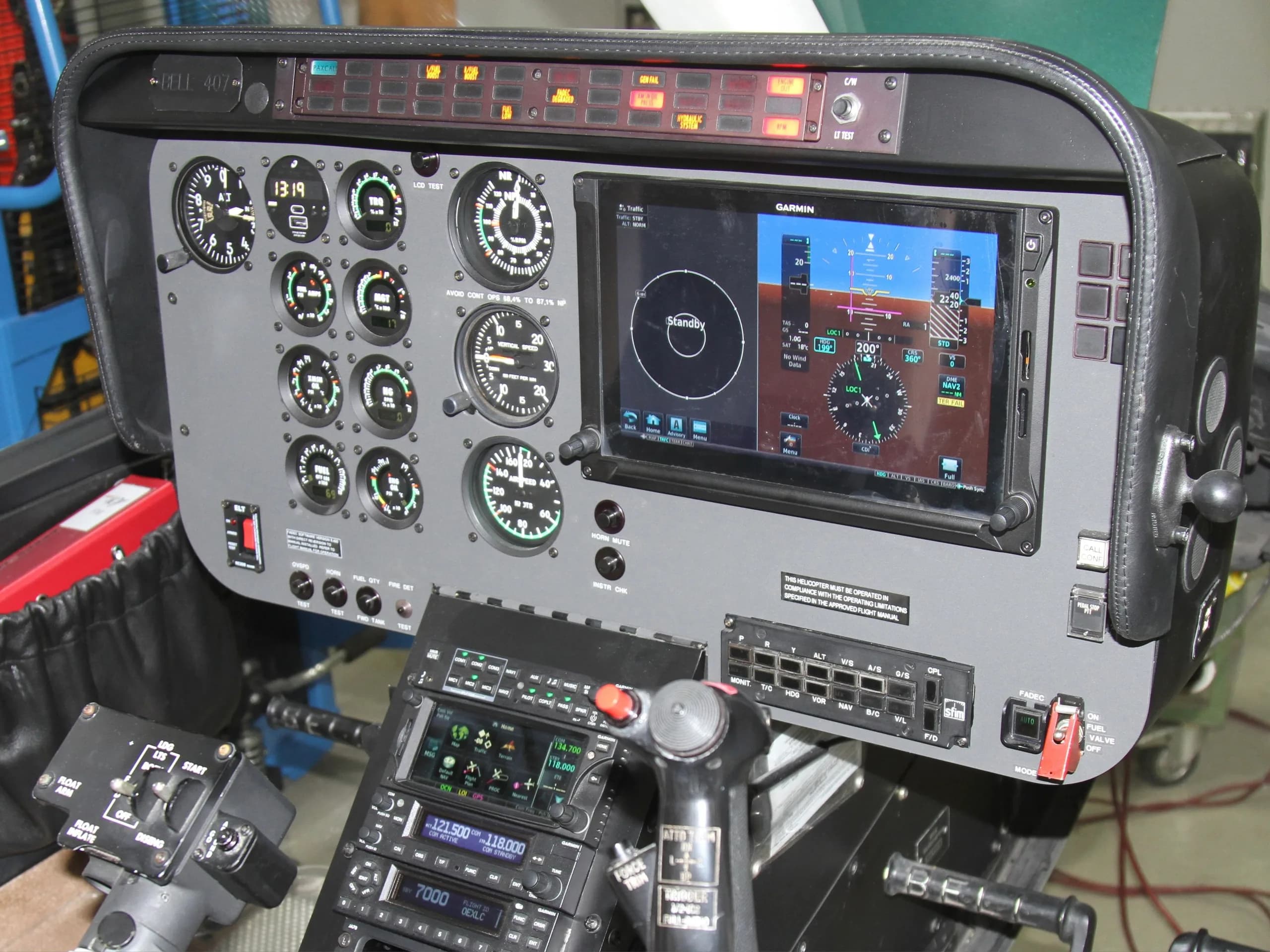 The cockpit instrument panel features a Garmin display and various gauges.