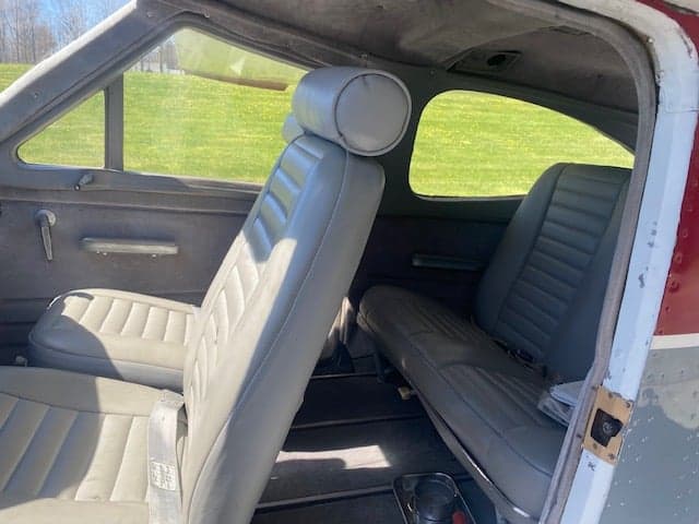 Rear seats of a Cessna 177 Cardinal, showing the gray upholstery and side panels.