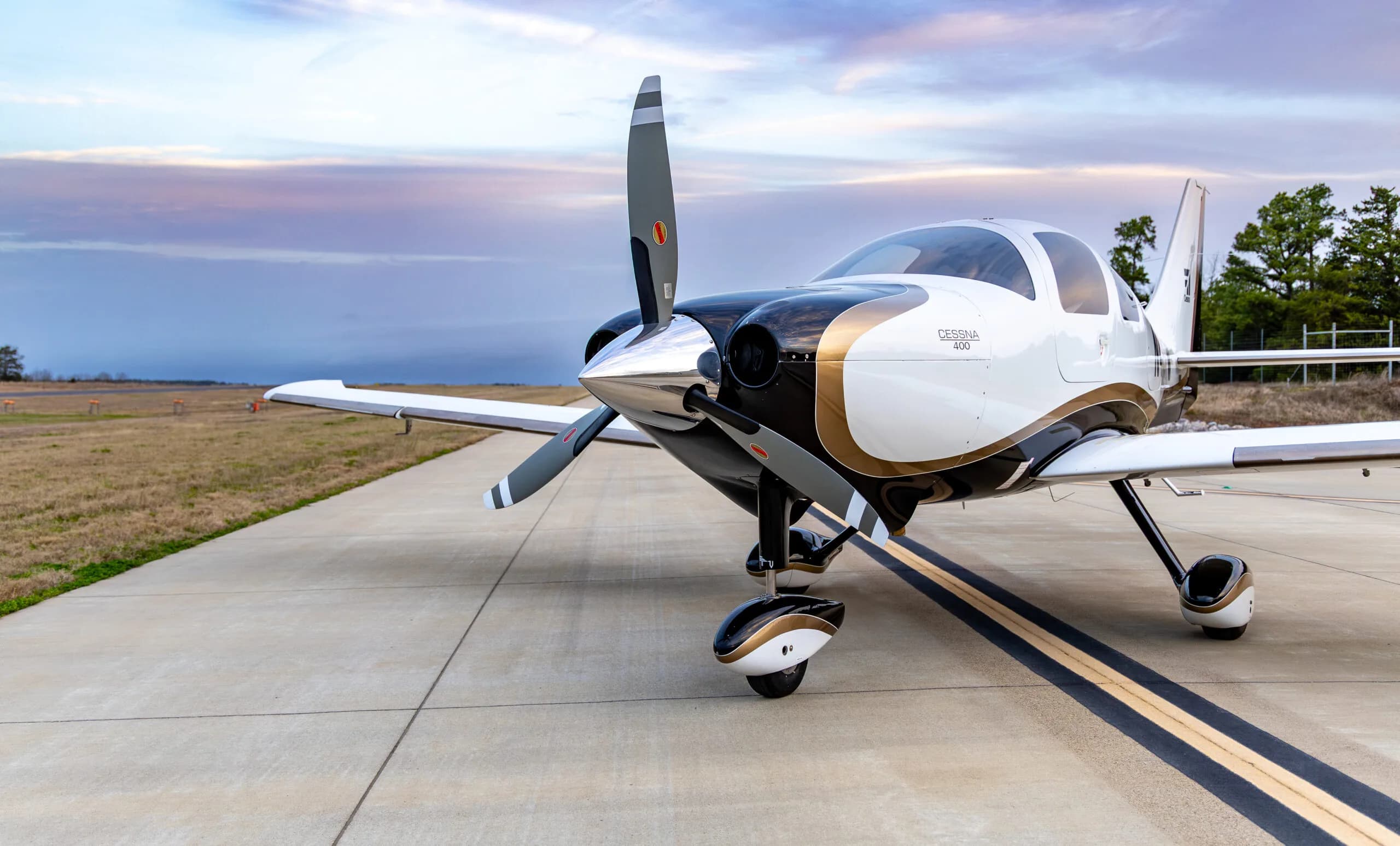 Close-up of the front of a Cessna 400, registration N410TW, parked on the tarmac.