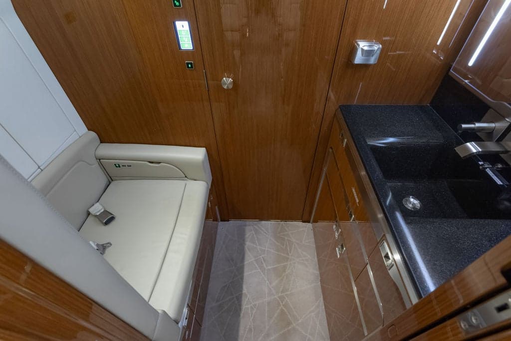 View of the aircraft's interior with a seat and sink.