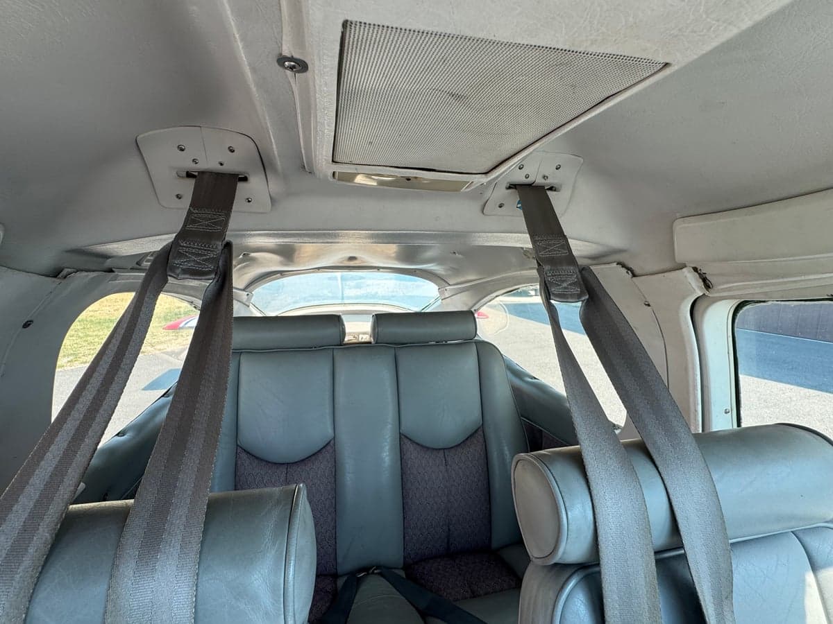 Rear seats of the Cessna cabin with seatbelts.
