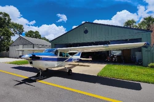 A Cessna 172 Skyhawk, registration N3374U, parked outside a hangar on a sunny day.