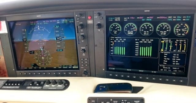 Close-up of the aircraft's avionics displays showing navigation and engine information.