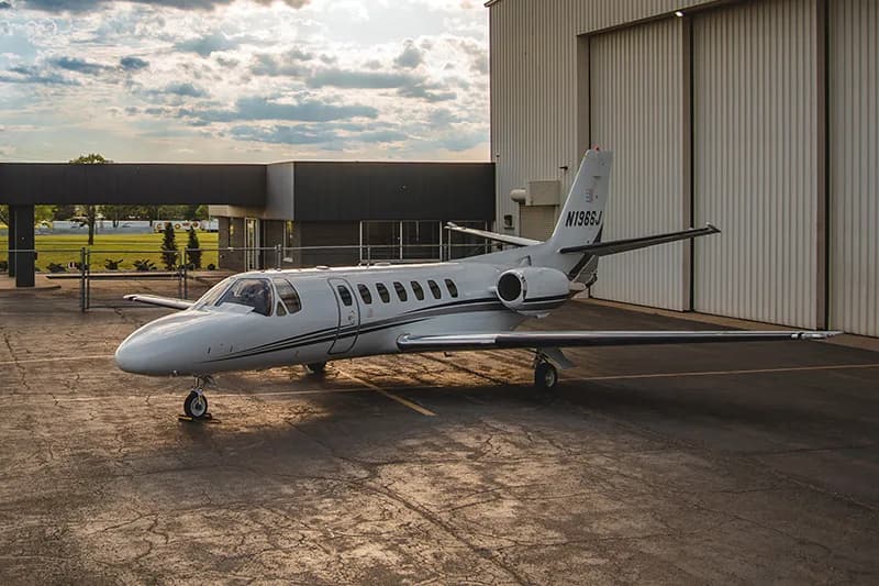 Cessna Citation CJ1+ aircraft N1966J parked outside a hangar.