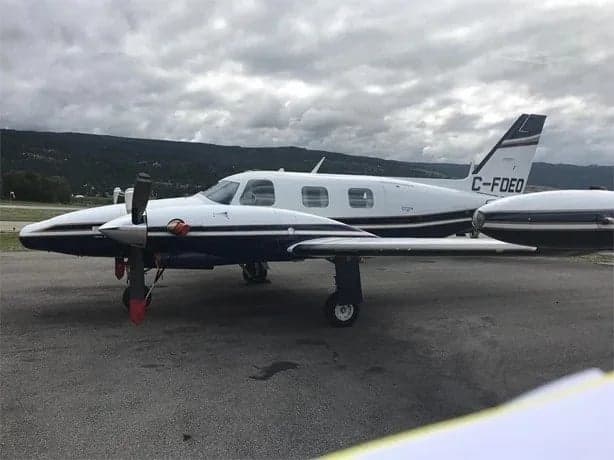 A Piper Aerostar aircraft is parked on the tarmac.