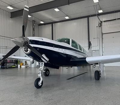Beechcraft Bonanza in a hangar, front view.