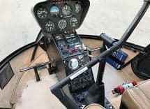 Interior view of the helicopter cockpit and instrument panel.