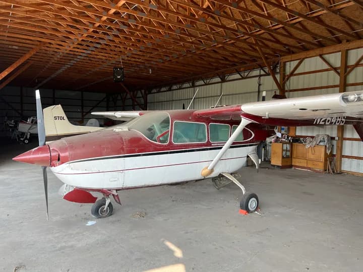 Side view of a Cessna aircraft inside a hangar.