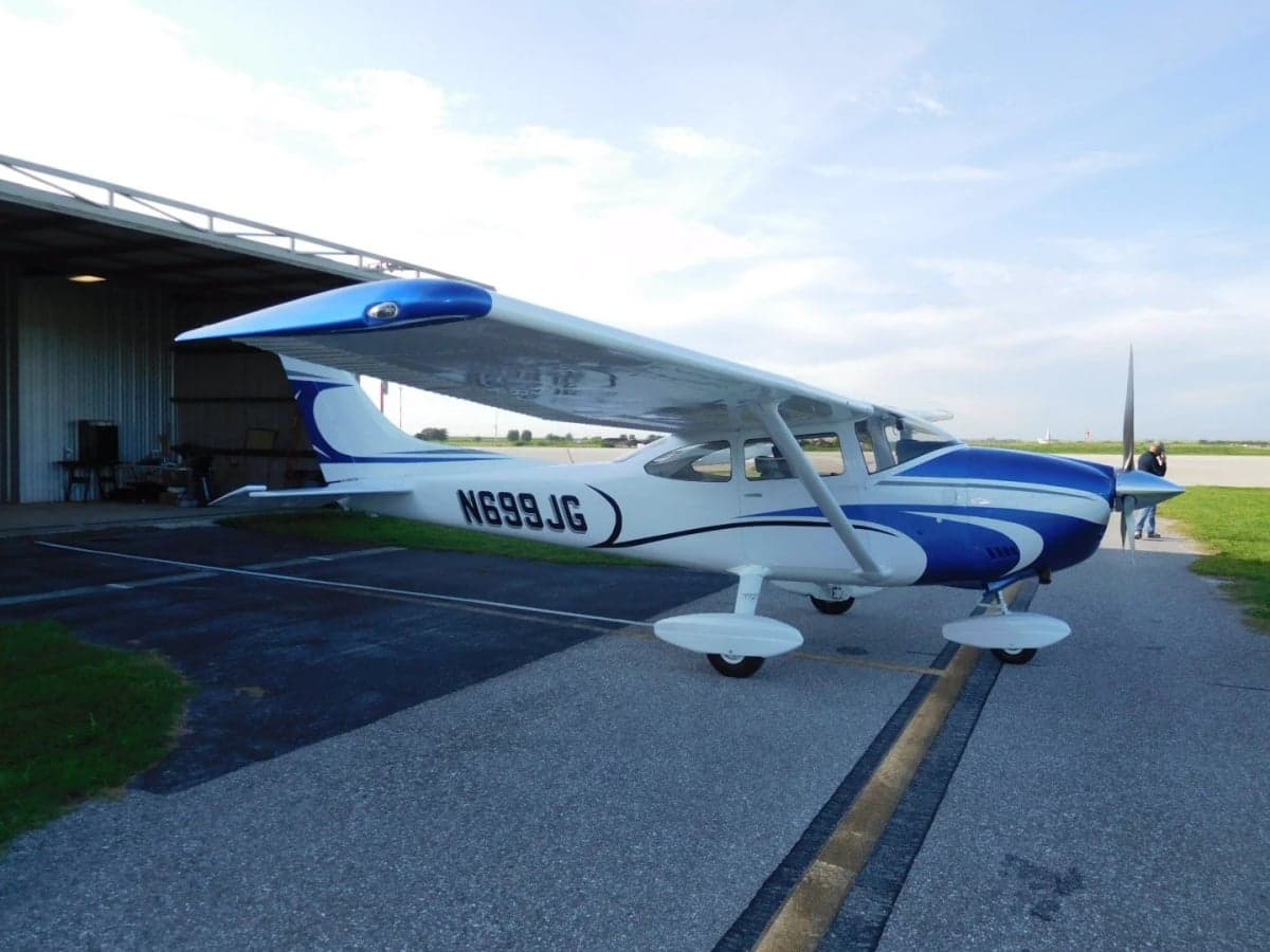 Full side view of the N699JG Cessna aircraft on the tarmac.
