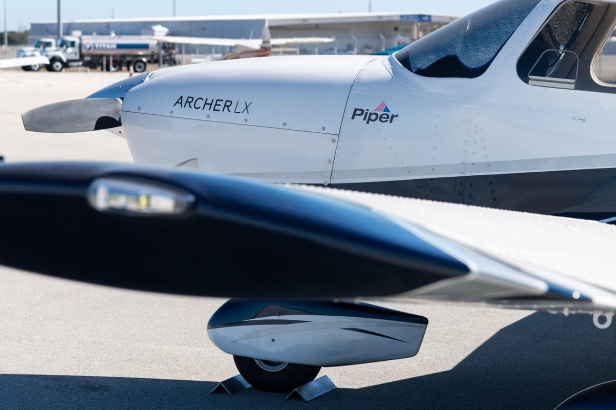 Close-up of the Piper Archer LX wing and nose, showing the Piper logo.