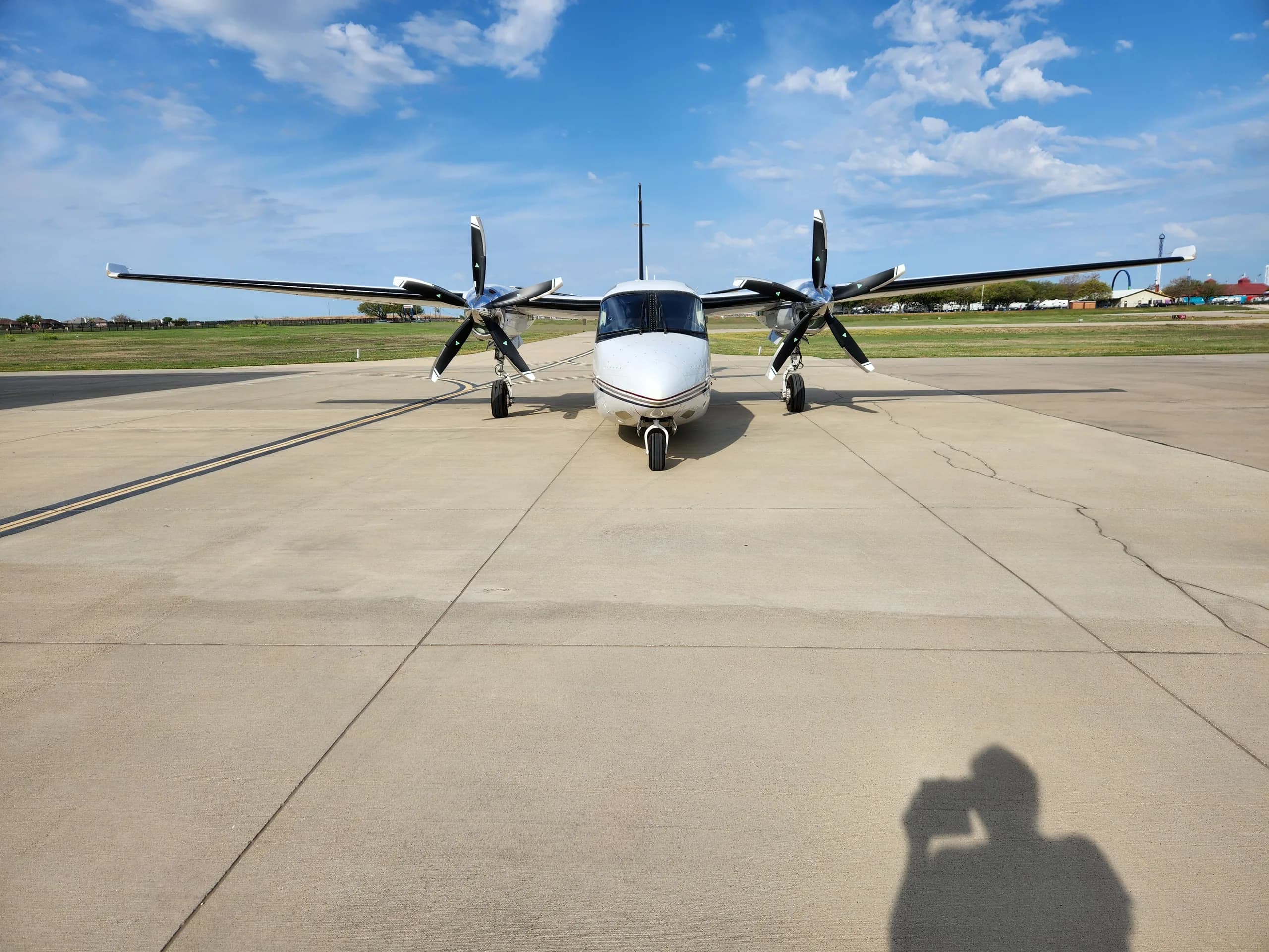 Front view of a white and black Commando aircraft parked on the tarmac.