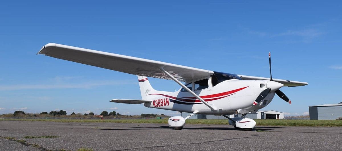 A Cessna Skylane aircraft with registration number N369AN is parked on the tarmac.