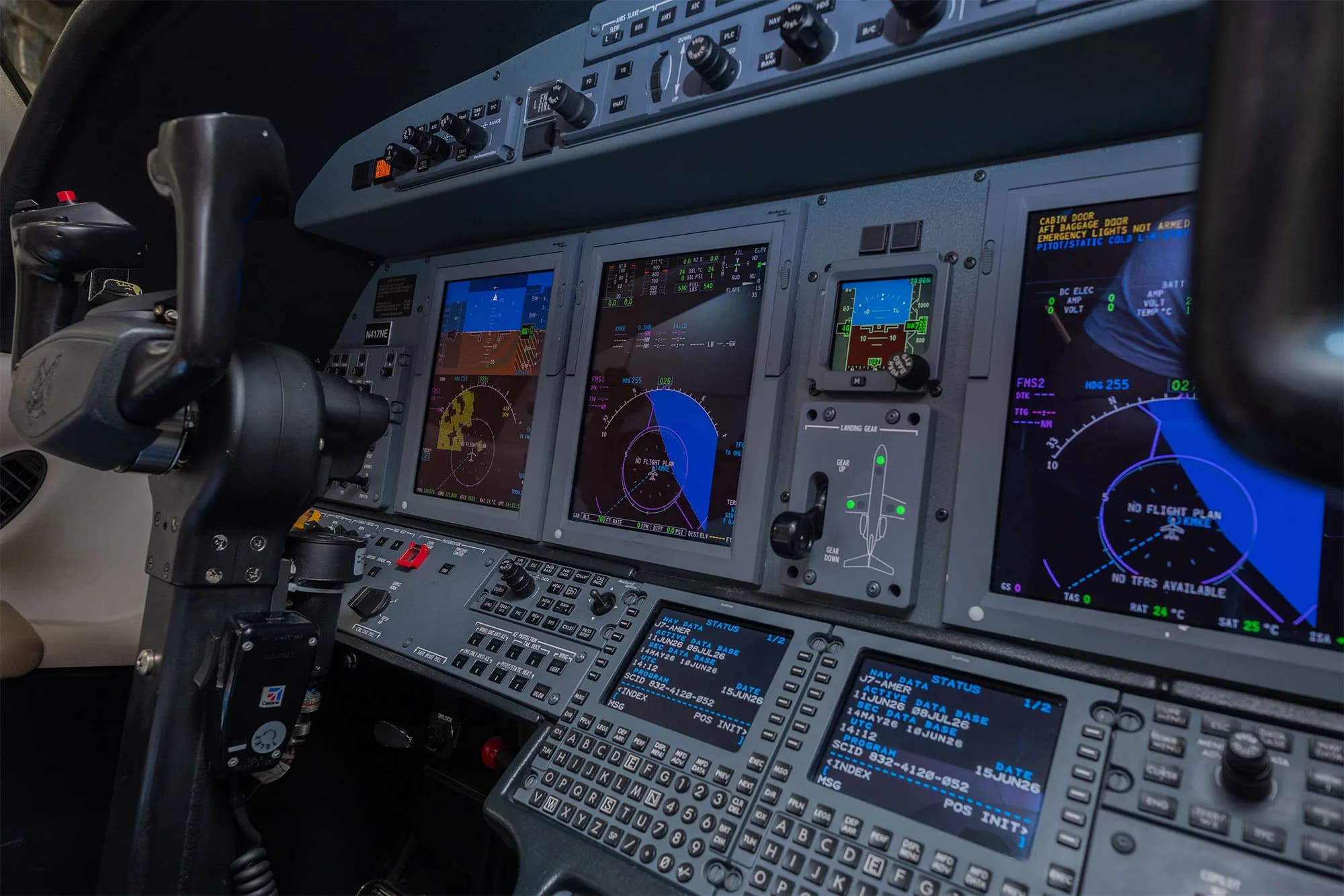A close-up view of the digital displays and controls in a business jet cockpit.