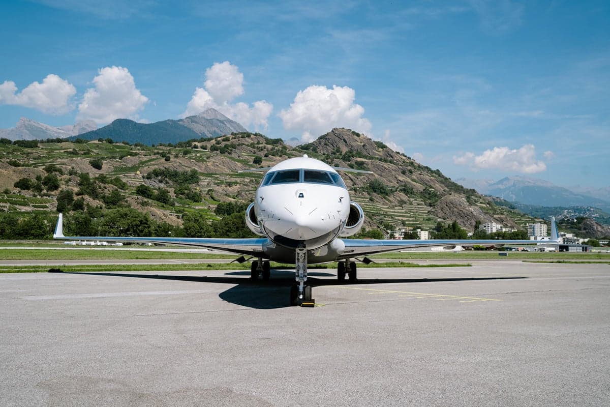 A head-on view of a Bombardier Global XRS aircraft parked on the tarmac.