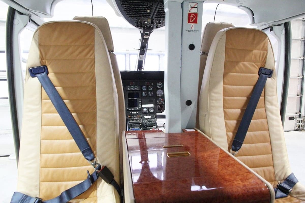 A view of the interior seats and cockpit of a helicopter.