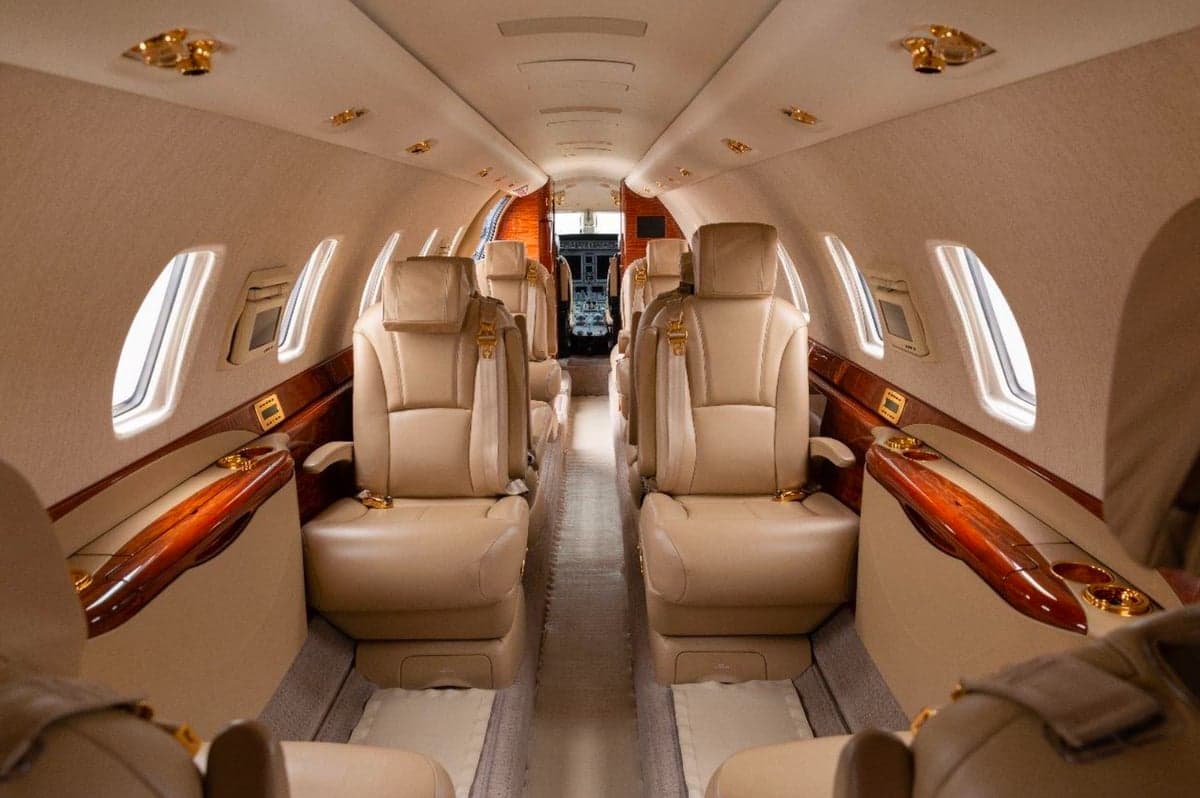 Full view of the leather seats in the aircraft cabin.