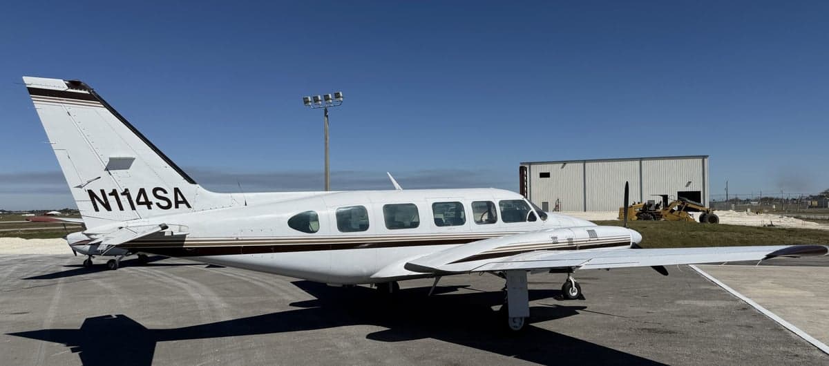 N114SA is a white and brown twin-engine aircraft on the tarmac.