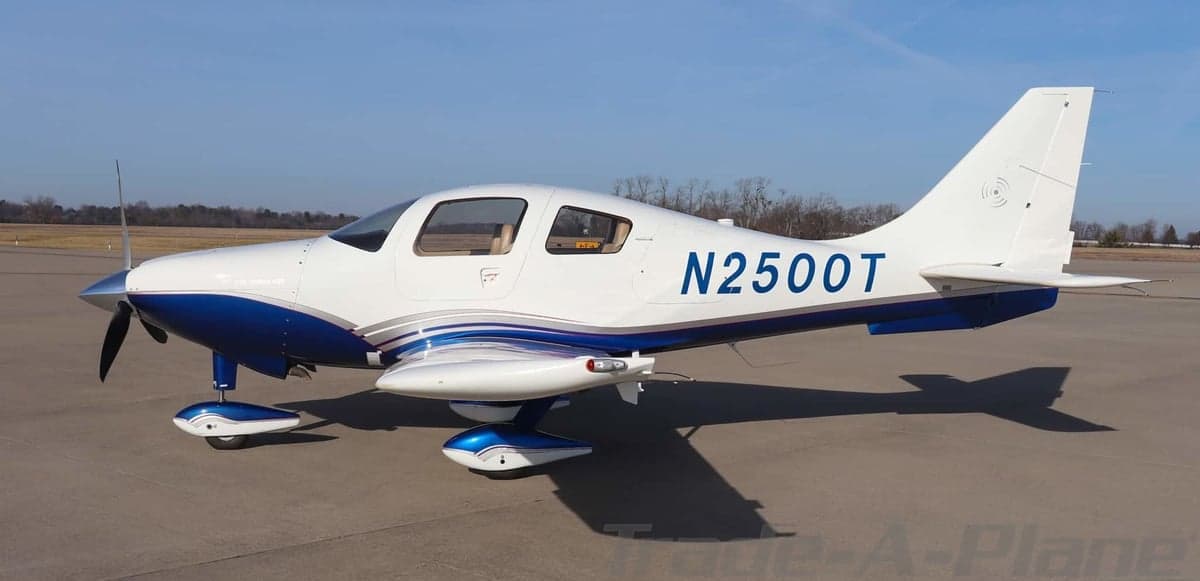 Side profile view of a white and blue Columbia 400 aircraft with registration N2500T on an airfield.