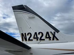 Close-up of the tail of a turboprop aircraft with registration N2424X.