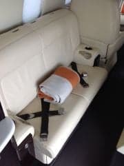 View of the aircraft's interior with a seat and a blanket.