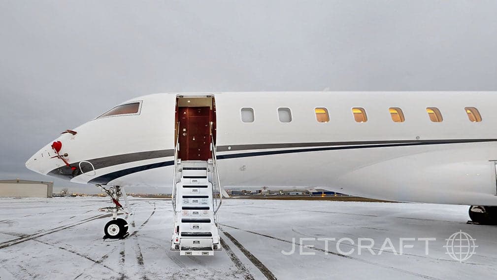 Close up of a white Bombardier Global Express with stairs extended.