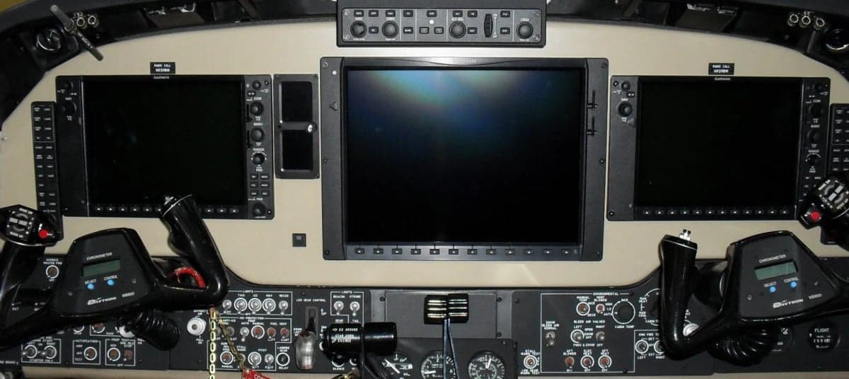 Aircraft cockpit instrument panel with large displays.