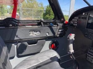 Interior view of the Cubcrafters XCub cockpit, showing the side panel and control stick.