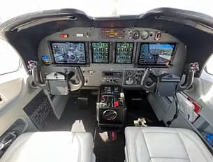 The cockpit of the aircraft features a modern glass panel display.