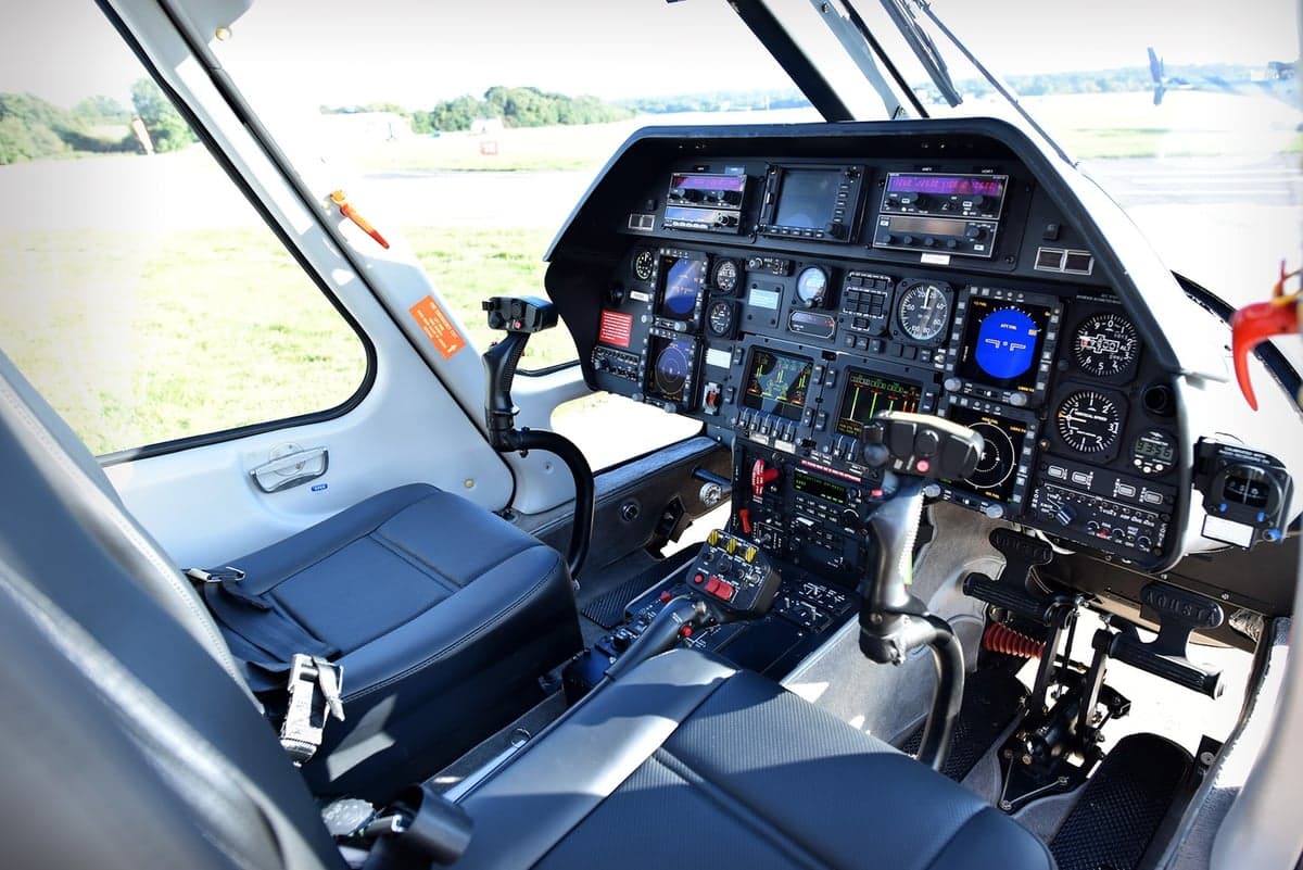 The cockpit of the helicopter features a full instrument panel and seating.