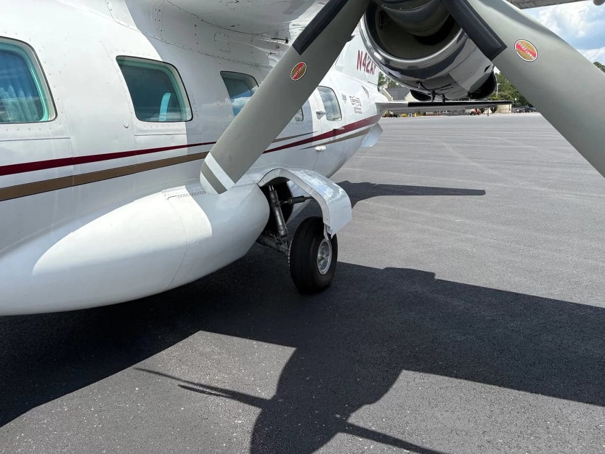 Close up of the aircraft's propeller and landing gear.