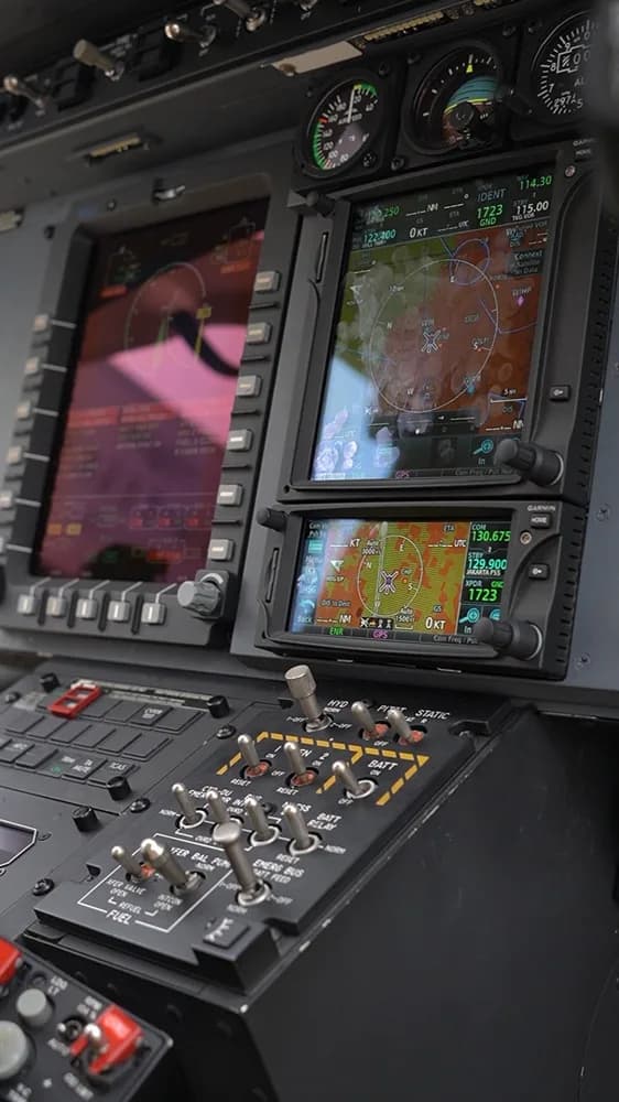 Close-up of the helicopter's instrument panel with navigation displays and switches.
