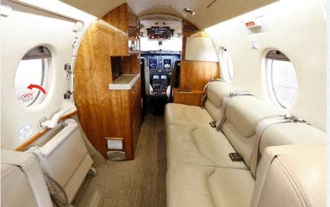 Interior view of the aircraft cabin, showing the seats and cockpit.