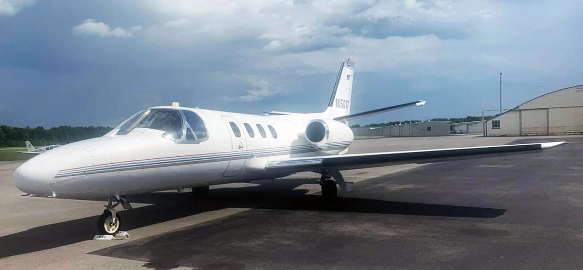 Side view of the white Cessna CitationJet N150TT on the tarmac.
