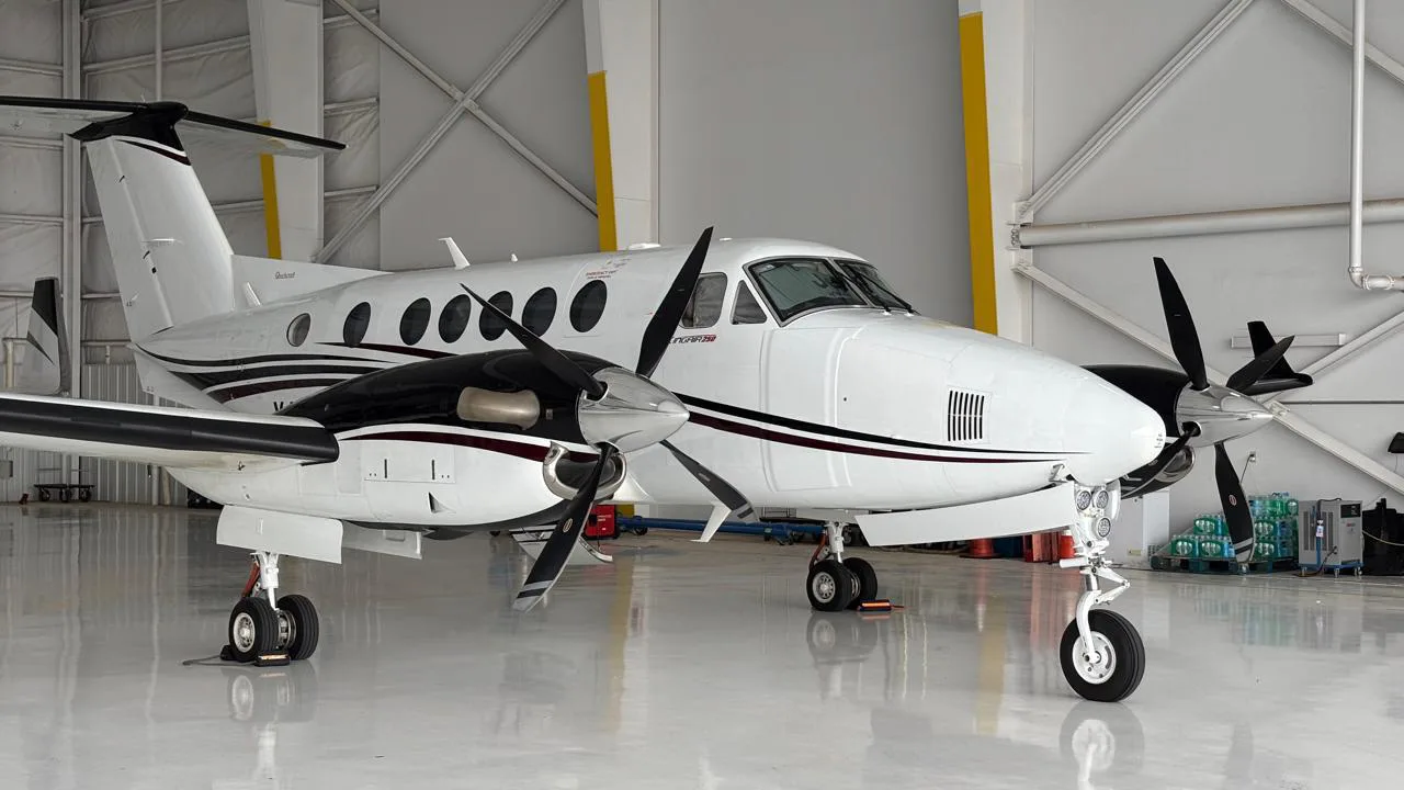 A King Air 350 twin turboprop aircraft is parked in a hangar.