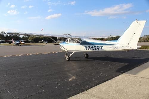 Cessna 150 aircraft N7459T on the tarmac at an airport.