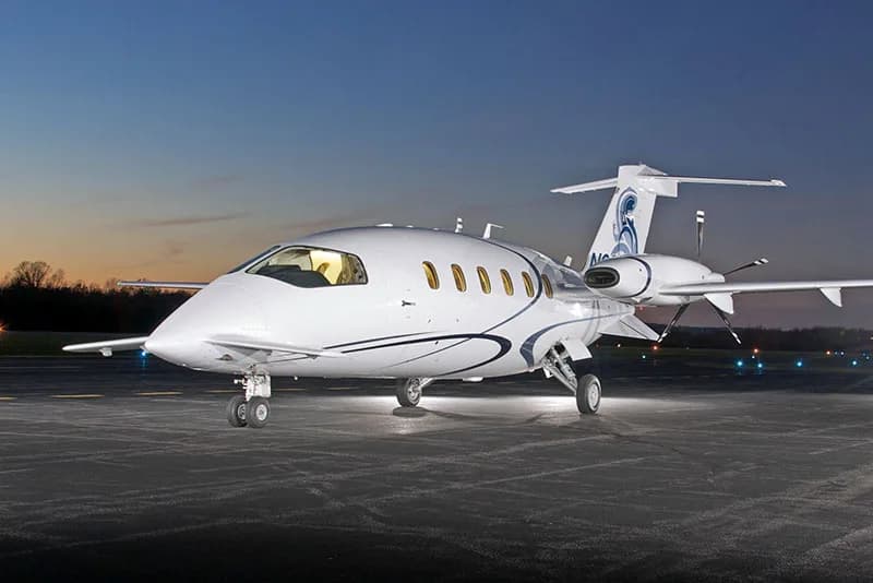 Piaggio Avanti EVO on the tarmac at dusk.