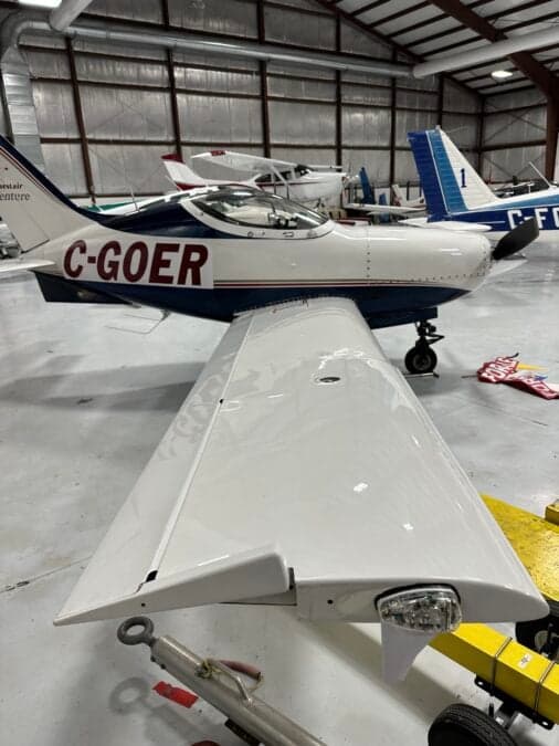A Questair Venture aircraft with registration C-GOER inside a hangar.