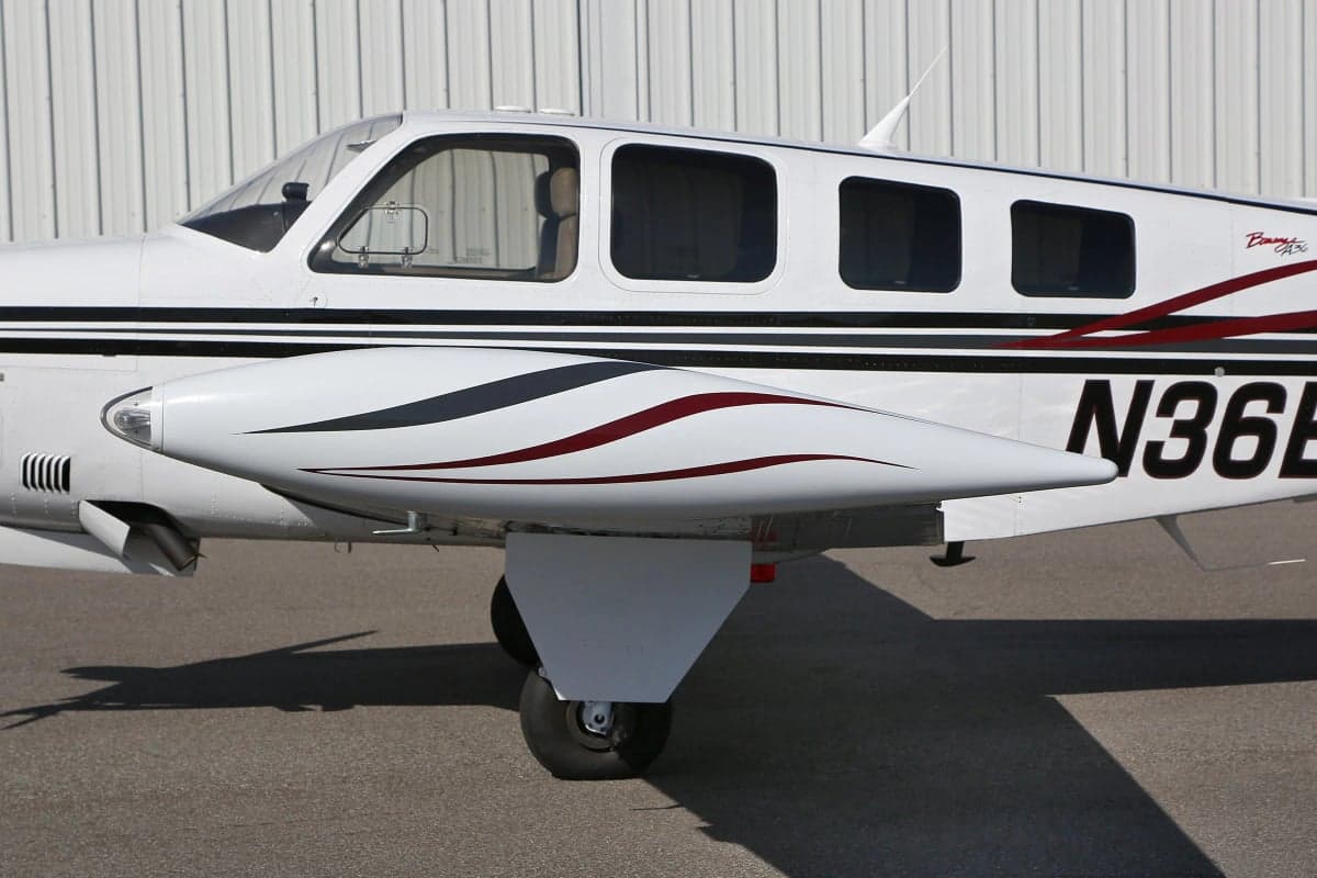 Close-up of the tail section of a Beechcraft Bonanza showing the registration number N36EK.