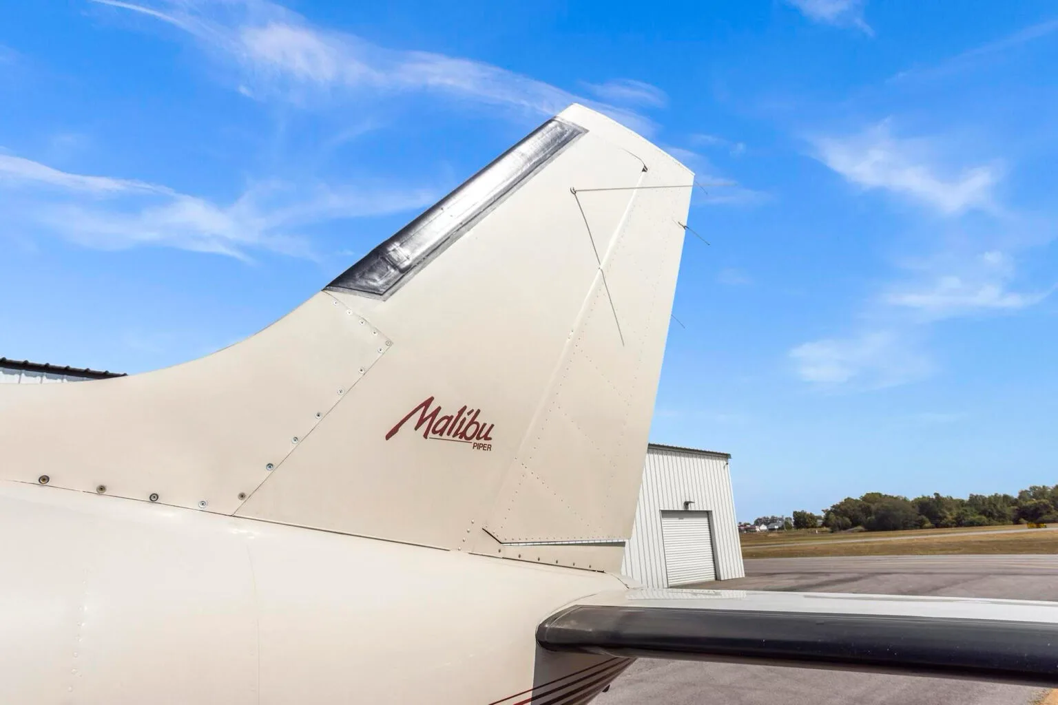 A close-up of the Piper Malibu N31BX tail, showing the "Malibu Piper" branding.
