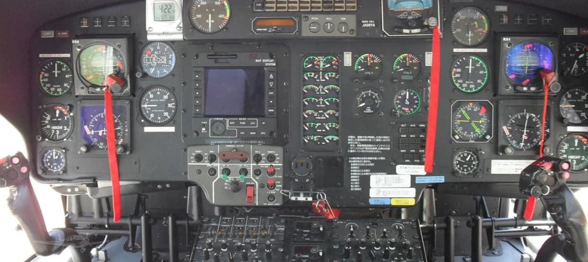 Close-up of the helicopter's instrument panel with various gauges and controls.