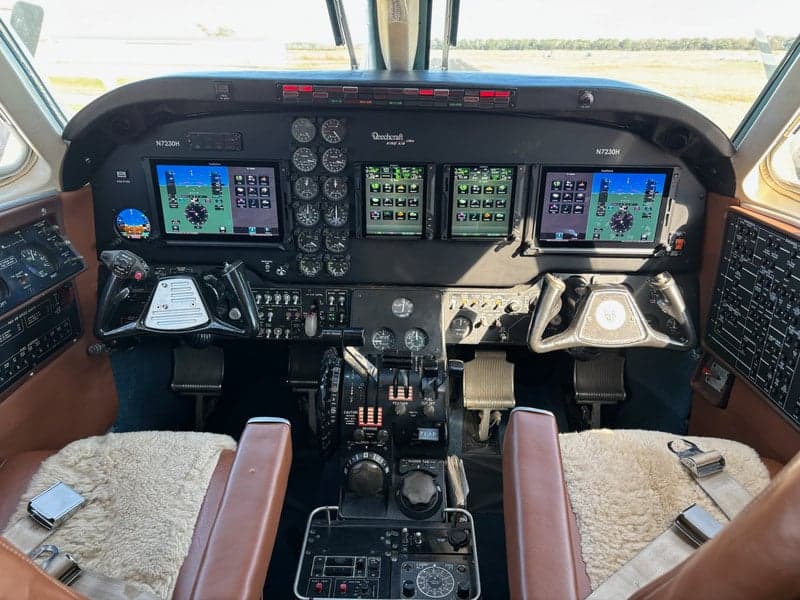 The cockpit of a Beechcraft King Air features modern avionics and classic controls.
