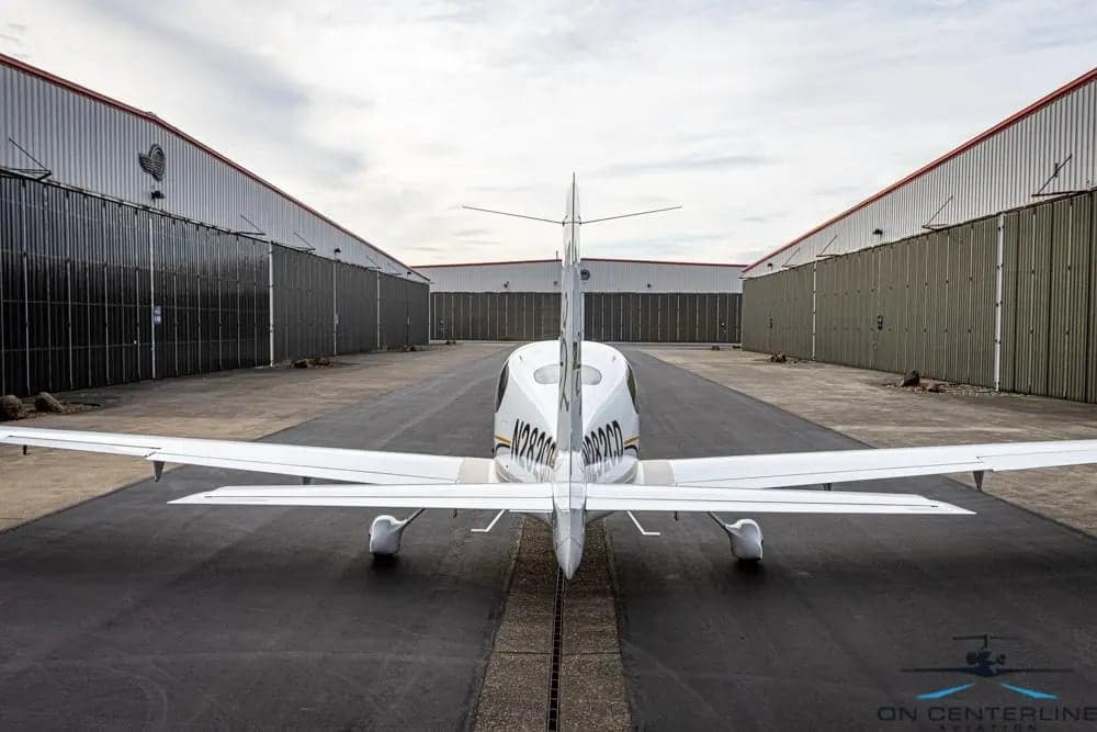 Rear view of Cirrus SR22T aircraft N282CD parked on the tarmac.
