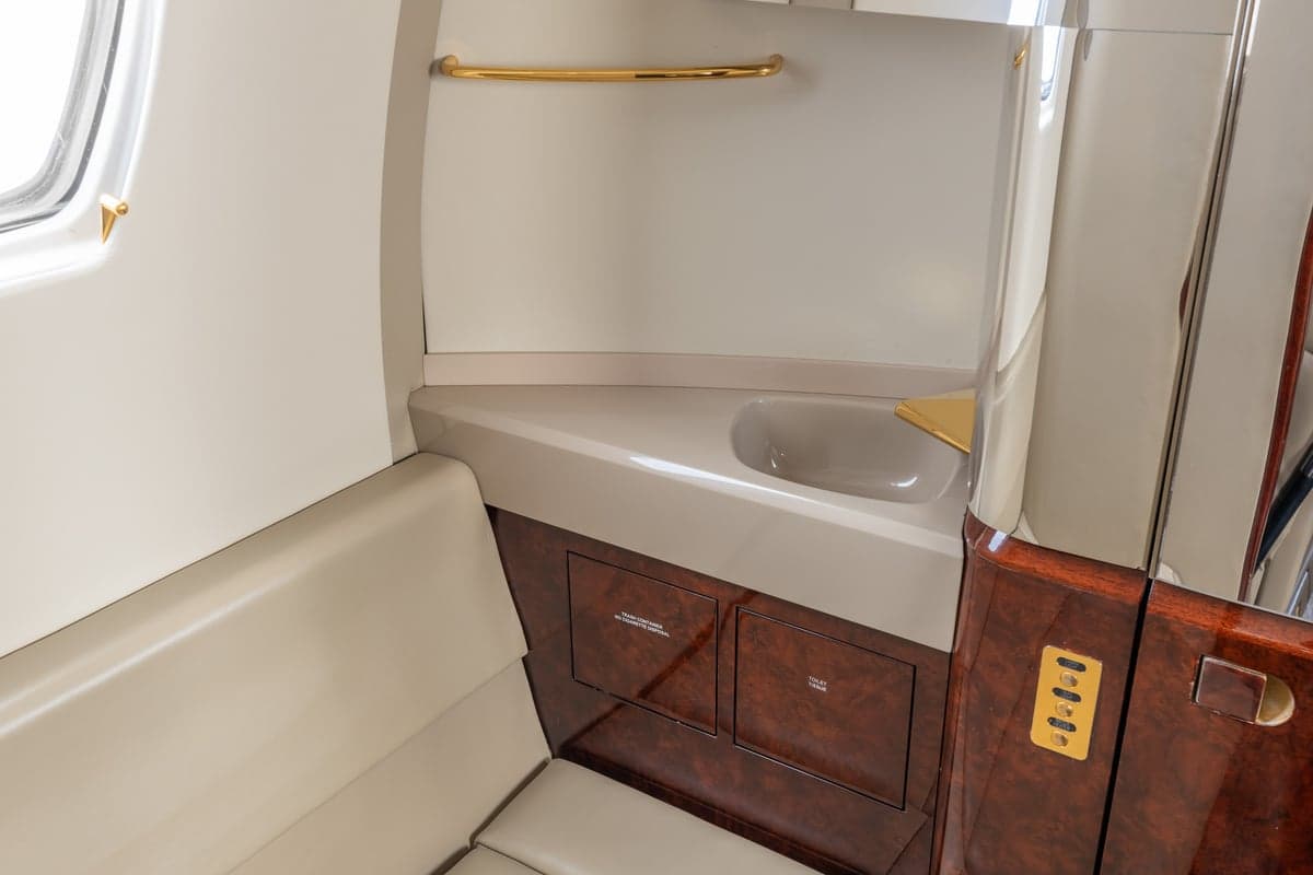 Close-up view of the aircraft lavatory sink and storage.